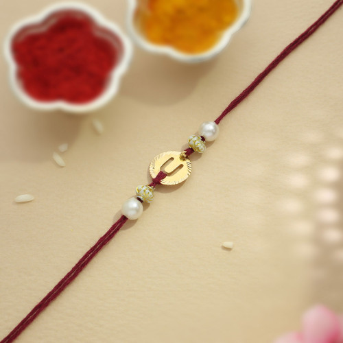 Malabar Gold Circle Motif U Alphabet Two-in-One Rakhi and Pendant