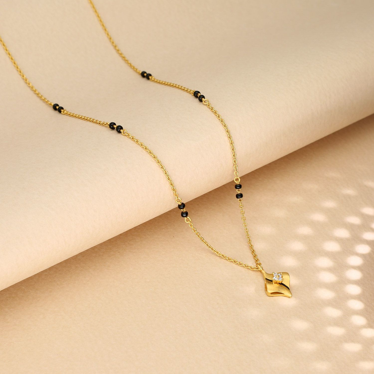 Short gold mangalsutra design hot sale