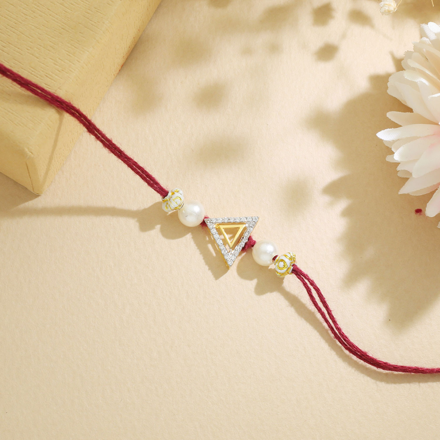 Malabar Gold Geometric Triangle Two-in-One Rakhi and Pendant
