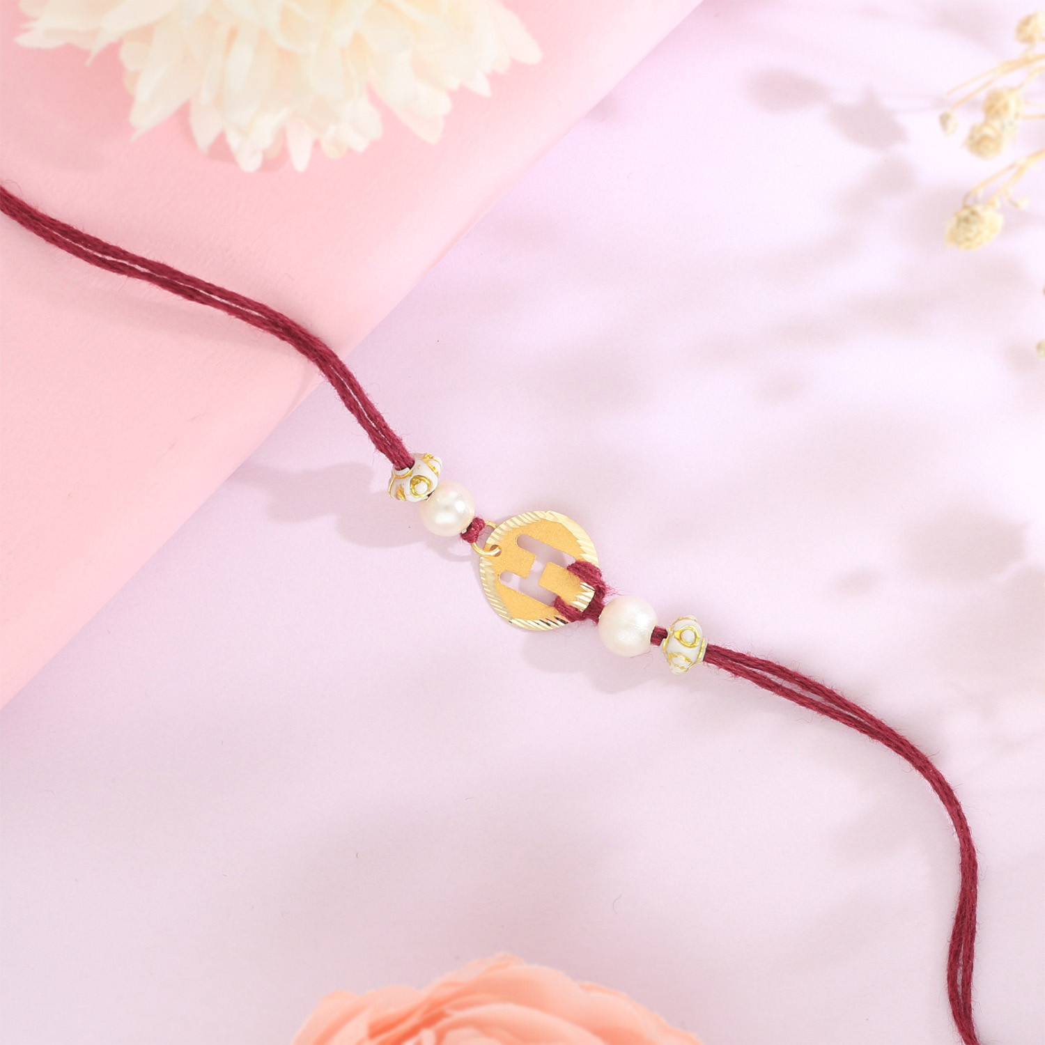 Malabar Gold Circle Motif H Alphabet Two-in-One Rakhi and Pendant
