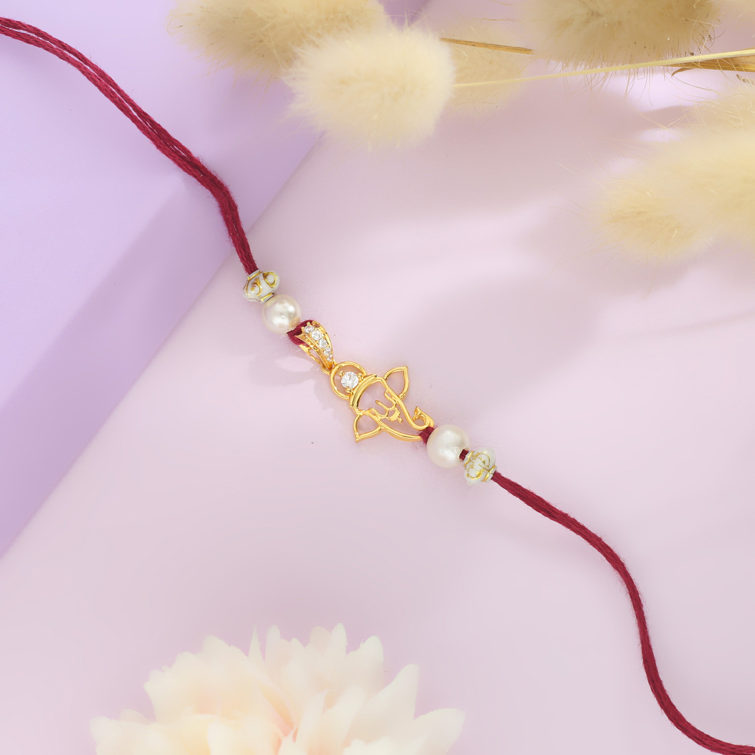 Malabar Gold Ganesh Motif Two-in-One Rakhi and Pendant