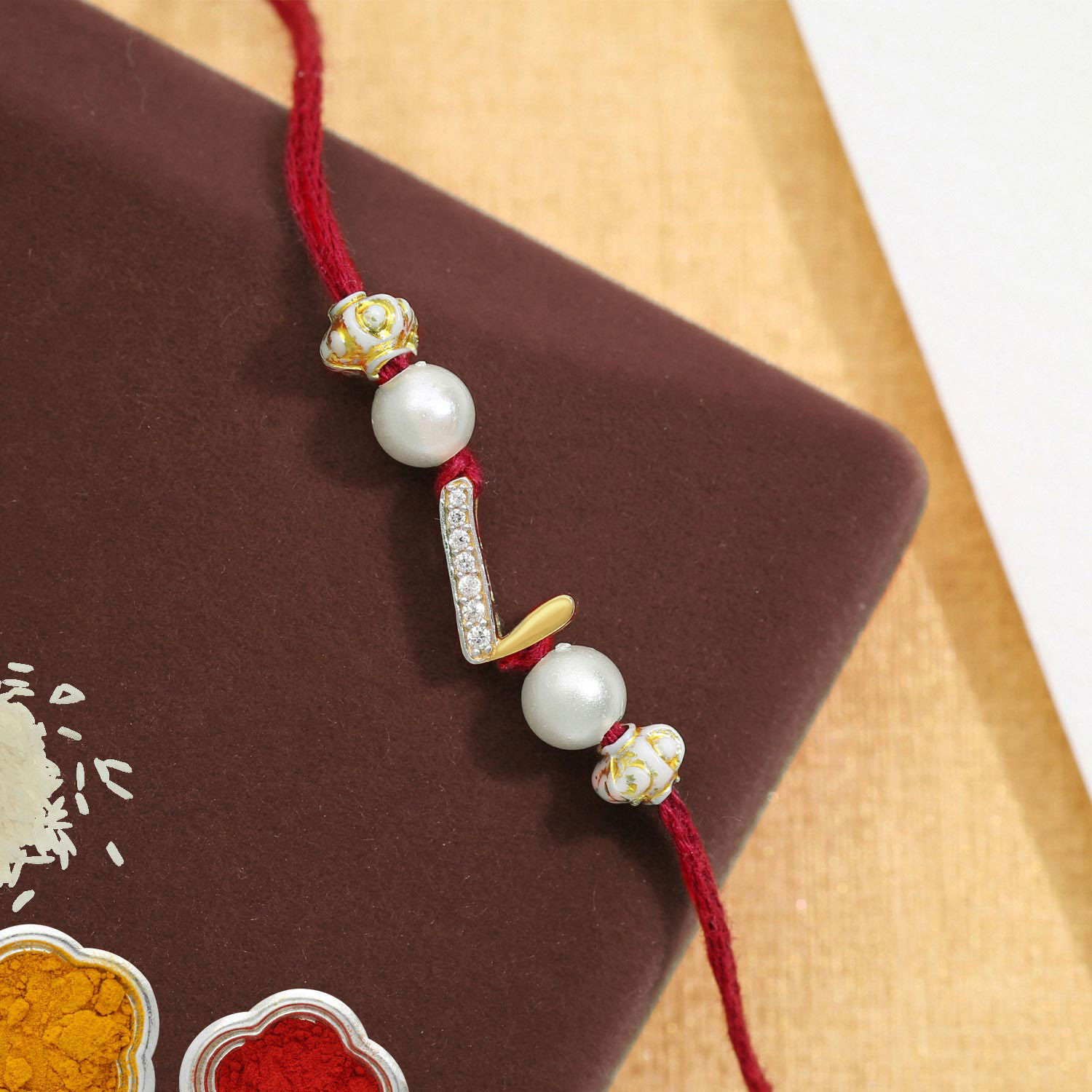 Malabar Gold Alphabet L Two-in-One Rakhi and Pendant
